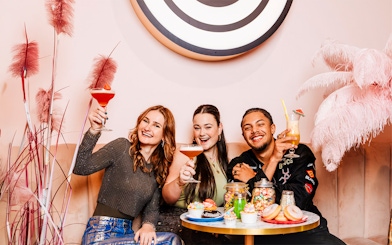 Group enjoying drinks and desserts at The Cafe at Upside Down Amsterdam.