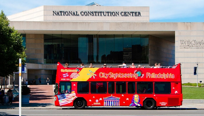 Red double-decker bus in front of the National Constitution Center, Philadelphia Hop-On-Hop-Off Tour.