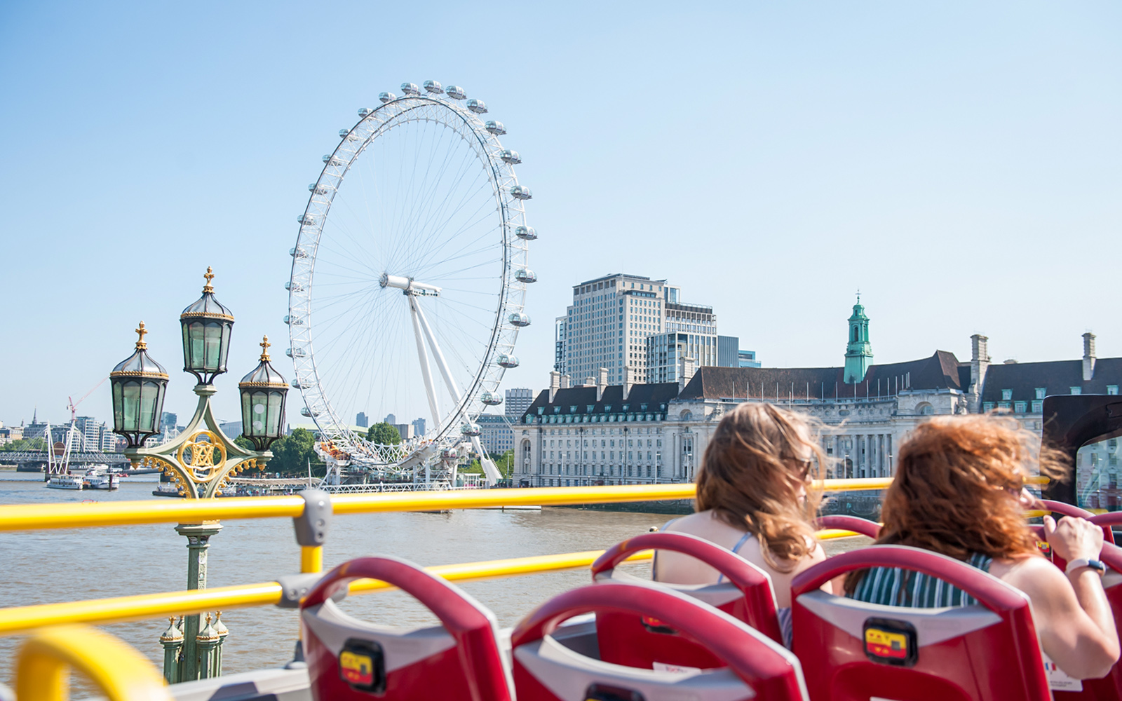 Open-top bus passing the London Eye on a Tootbus tour.