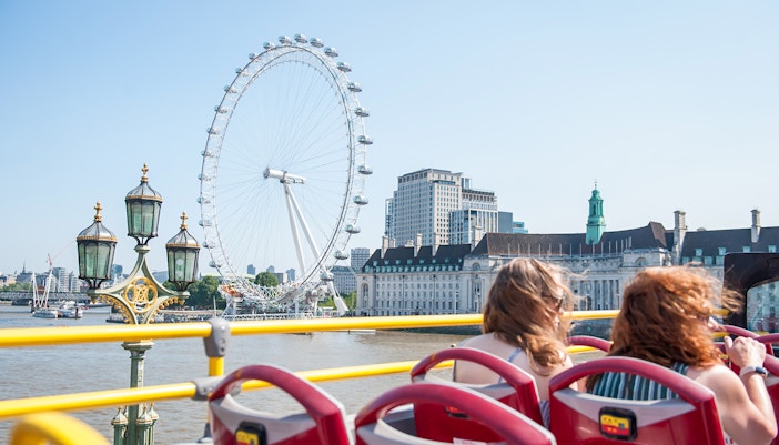 Open-top bus passing the London Eye on a Tootbus tour.