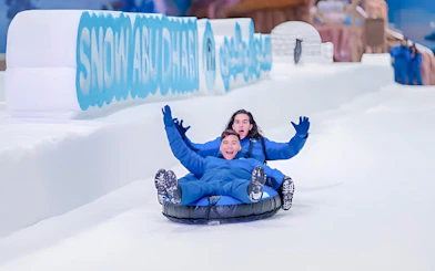 Visitors tubing at Snow Abu Dhabi indoor snow park, Abu Dhabi.