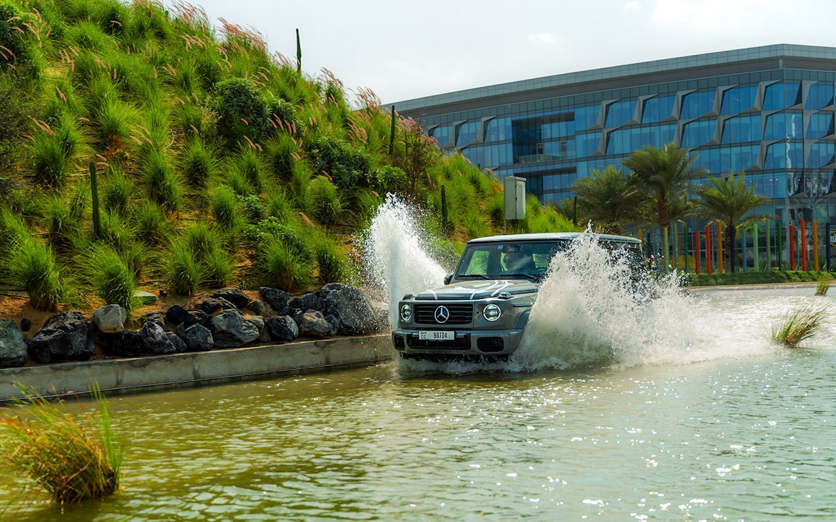 Mercedes-Benz driving through water at Dubai experience tour.