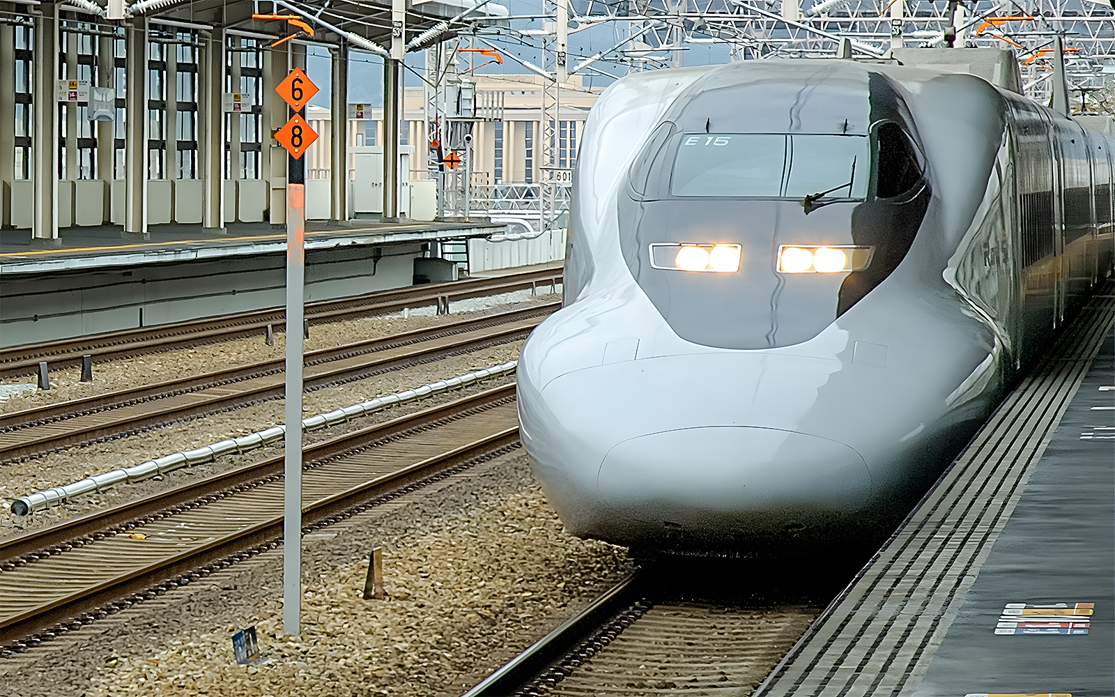 Hikari Shinkansen bullet train at a station platform in Japan.