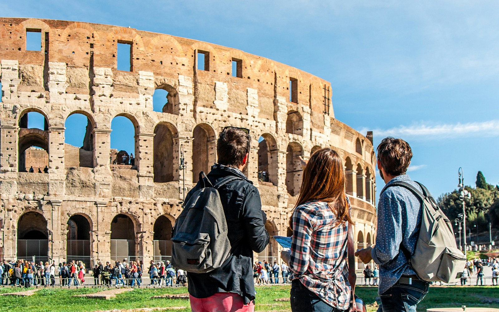 Tourists exploring the Colosseum's underground and gladiator arena in Rome.