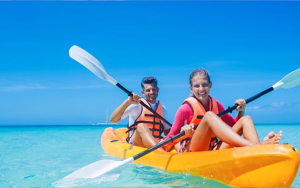 Kayakers paddling in clear waters during a Dubai tour.
