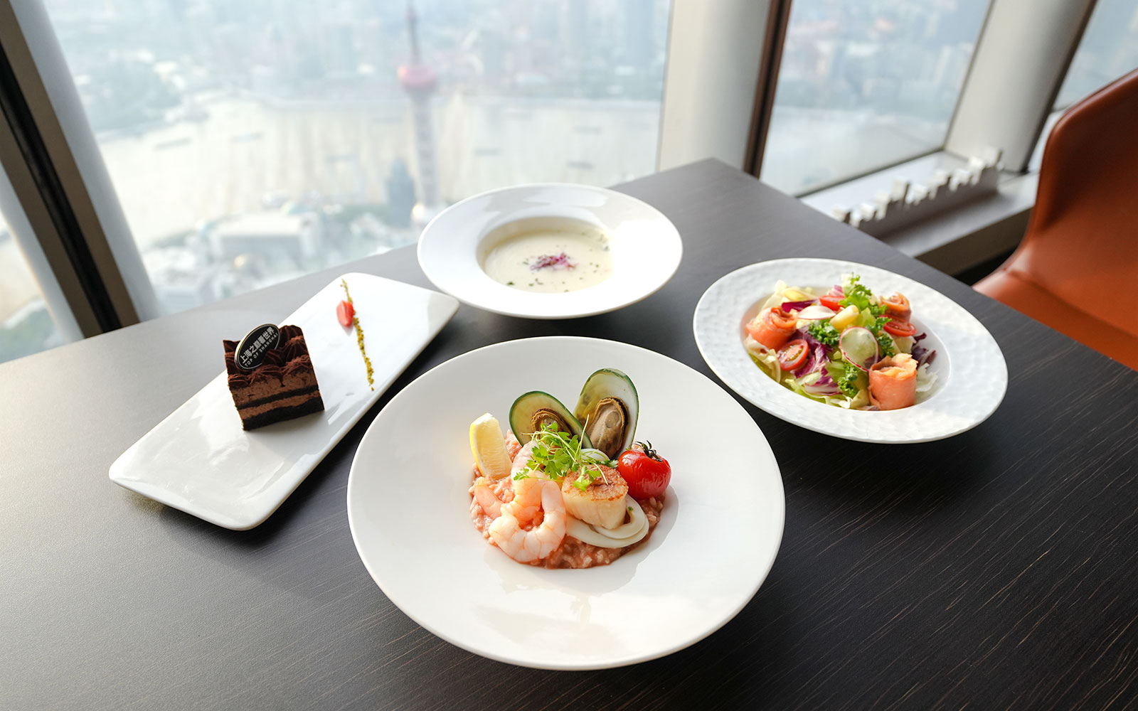 Seafood and salad dishes with dessert at a Shanghai Tower restaurant.