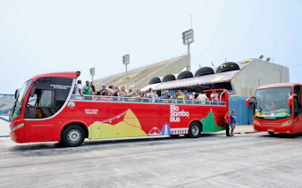 Rio de Janeiro hop-on hop-off bus with tourists at Sambadrome.