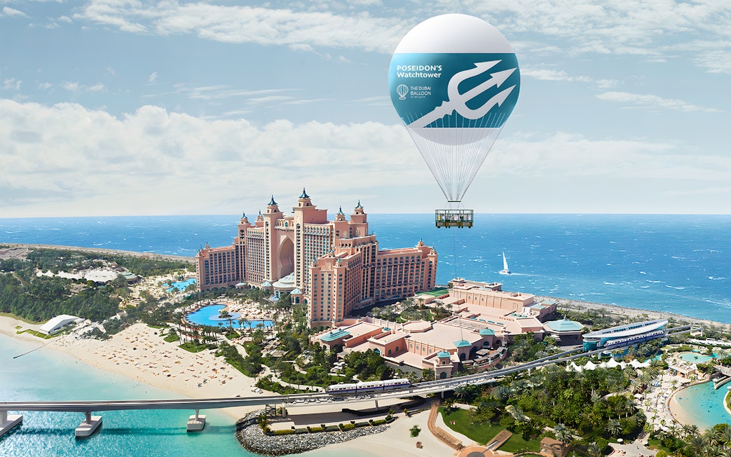 Hot air balloon over Atlantis The Palm, Dubai with ocean view.