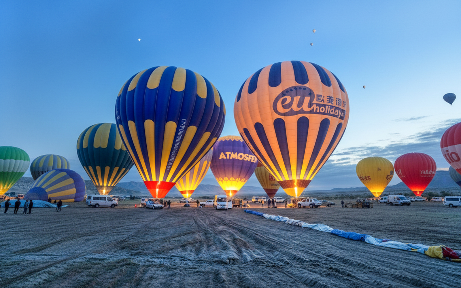 Hot air balloons preparing for flight in Gerome Valley, Cappadocia at dawn.