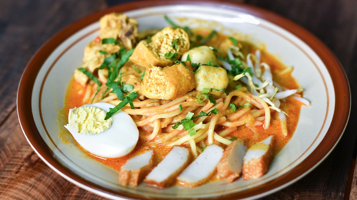 Chicken ramen bowl with sliced green onions and soft-boiled egg in Tokyo, Japan.