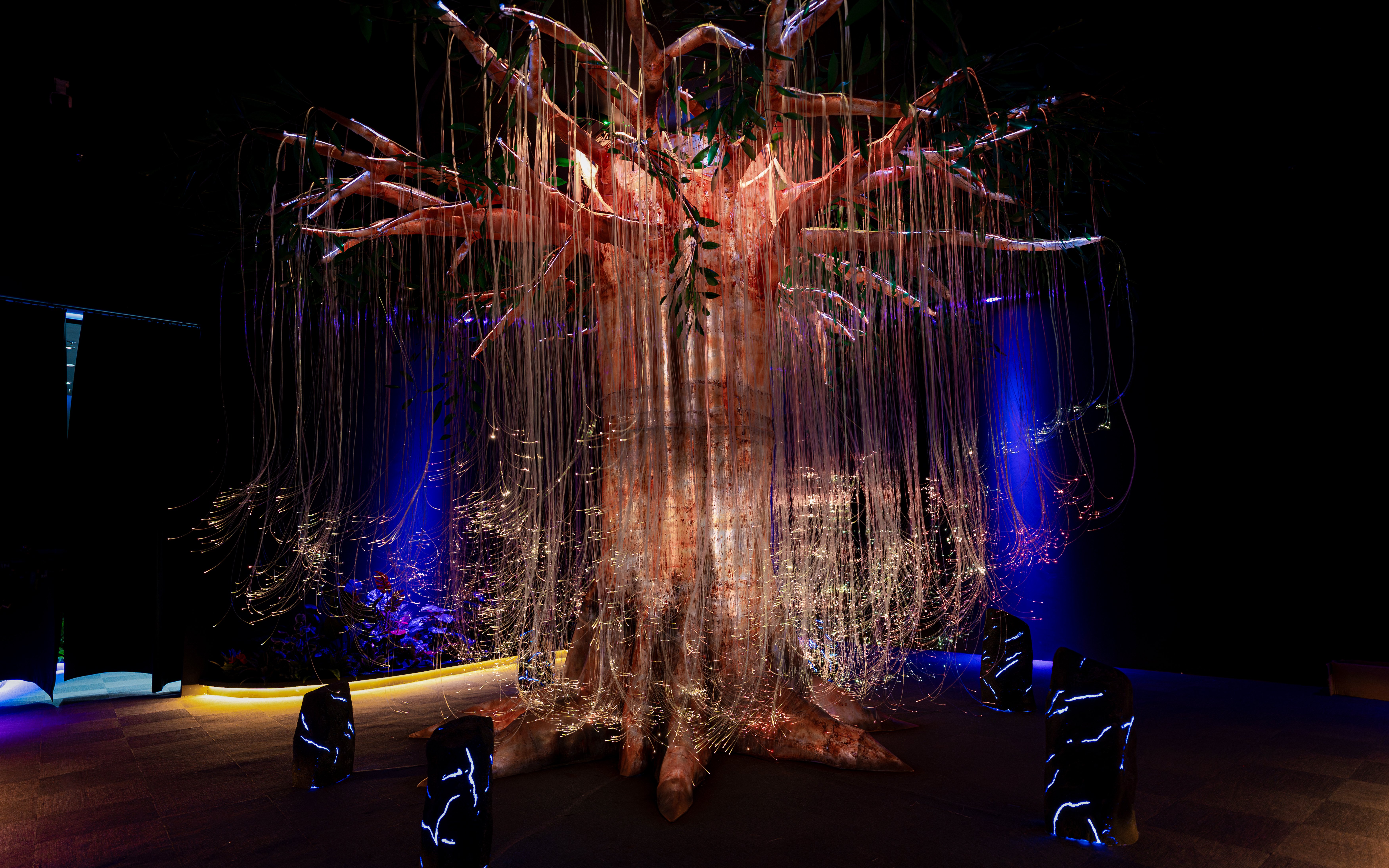 Cosmic tree installation with glowing lights at Enchanted Forest.