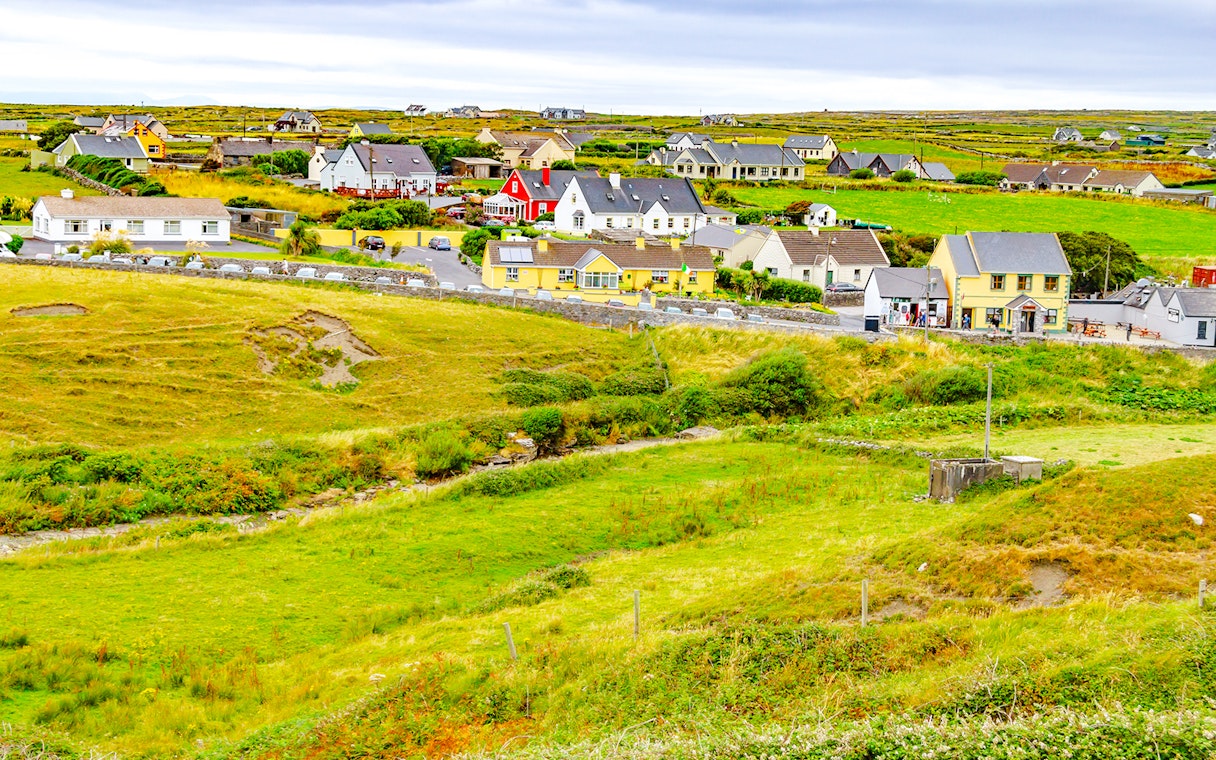 Doolin Village landscape with colorful houses and green fields in County Clare, Ireland.
