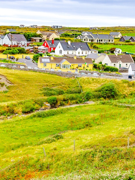 Doolin Village landscape with colorful houses and green fields in County Clare, Ireland.