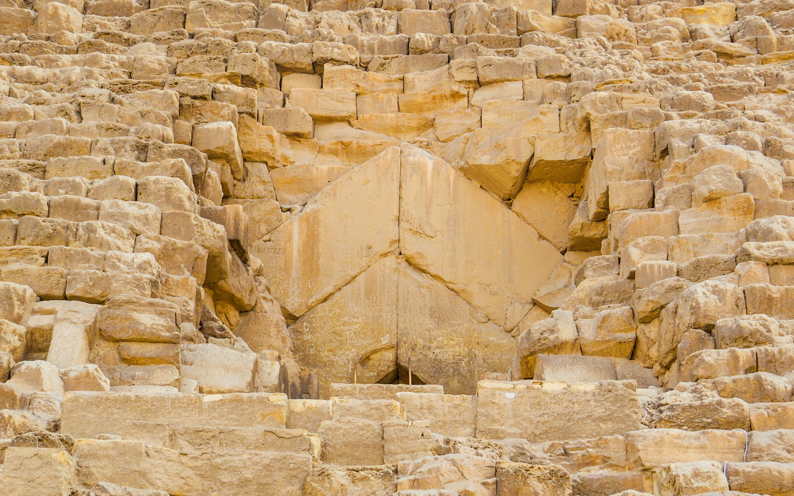 Entrance detail of the Pyramid of Giza, showcasing ancient stonework.