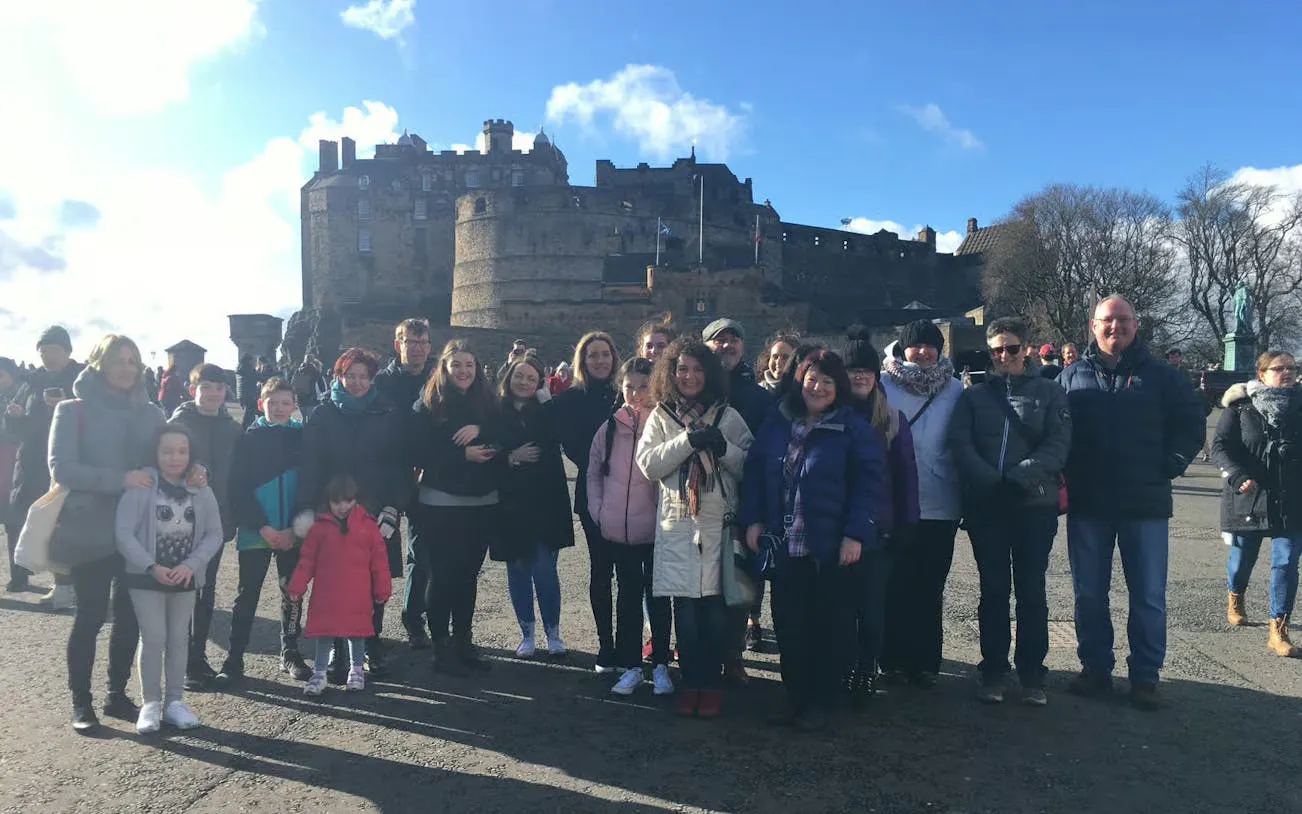 Group of tourists in front of Edinburgh Castle during a guided walking tour.