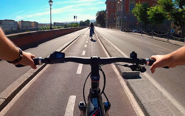 E-bike ride on Piazzale Michelangelo with view of Florence buildings and hills.