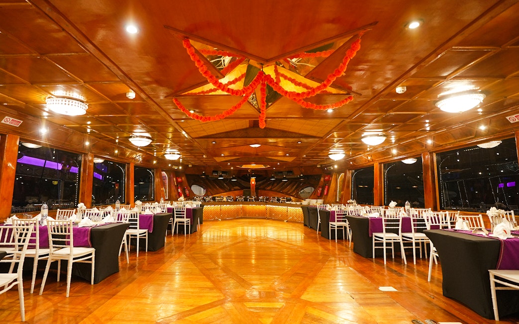 Luxury dining setup on a dhow cruise in Dubai Marina with elegant table arrangements.