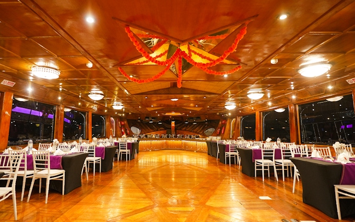 Luxury dining setup on a dhow cruise in Dubai Marina with elegant table arrangements.
