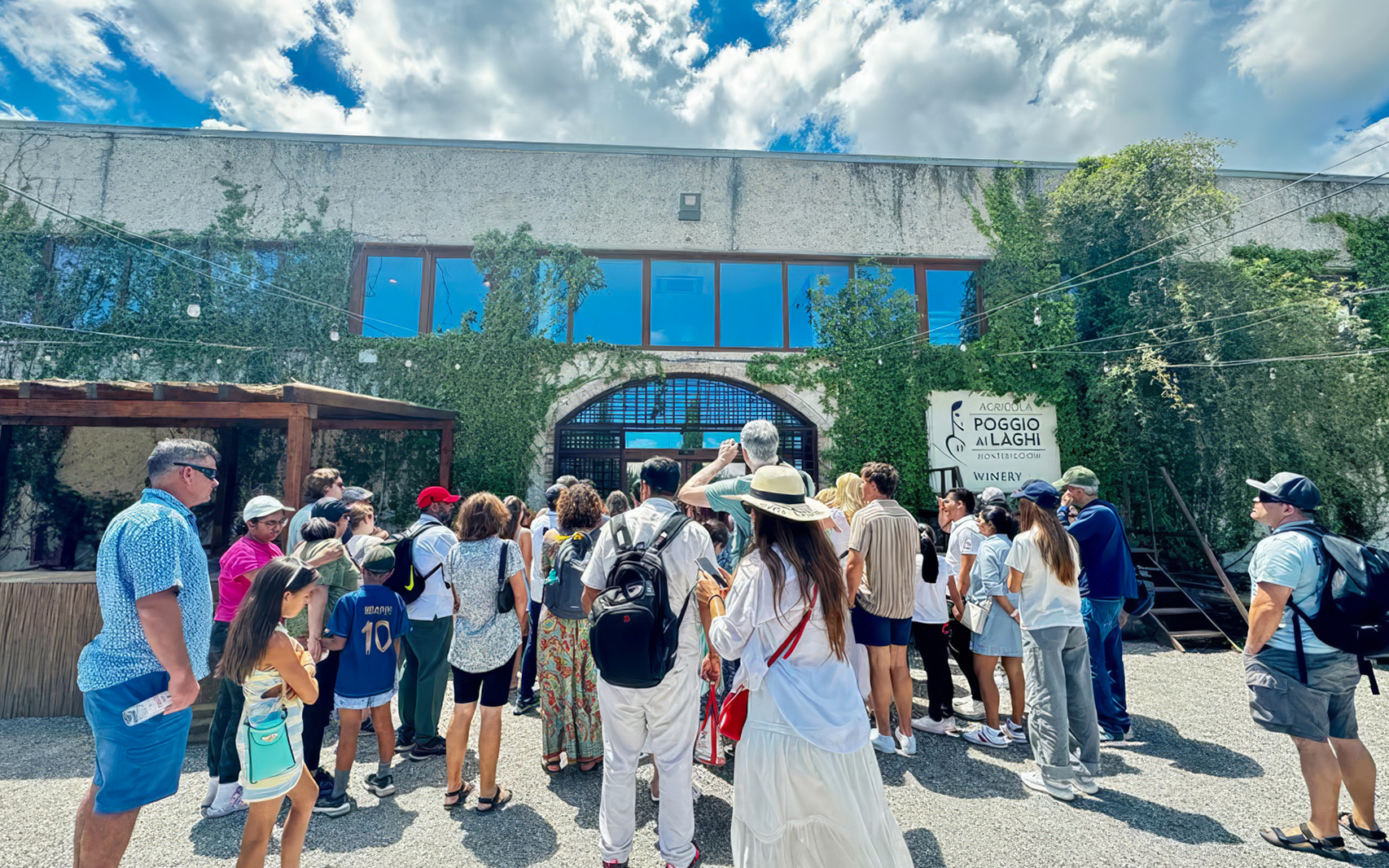 Visitors entering Poggio ai Laghi winery in Chianti, Italy.