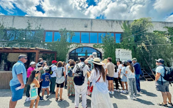 Visitors entering Poggio ai Laghi winery in Chianti, Italy.
