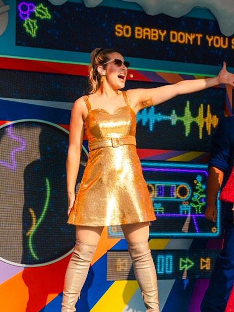 Performers in festive outfits singing at Universal Studios Singapore Christmas event.