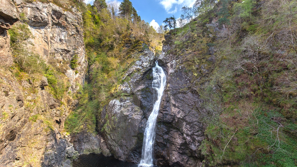 Waterfall cascading down rocky cliffs at The Falls of Foyers, Scotland.