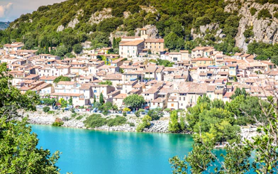 Village by Lake of Sainte-Croix with Gorges du Verdon backdrop.