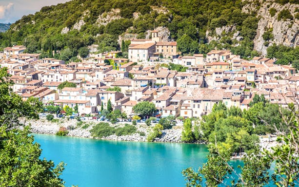 Village by Lake of Sainte-Croix with Gorges du Verdon backdrop.