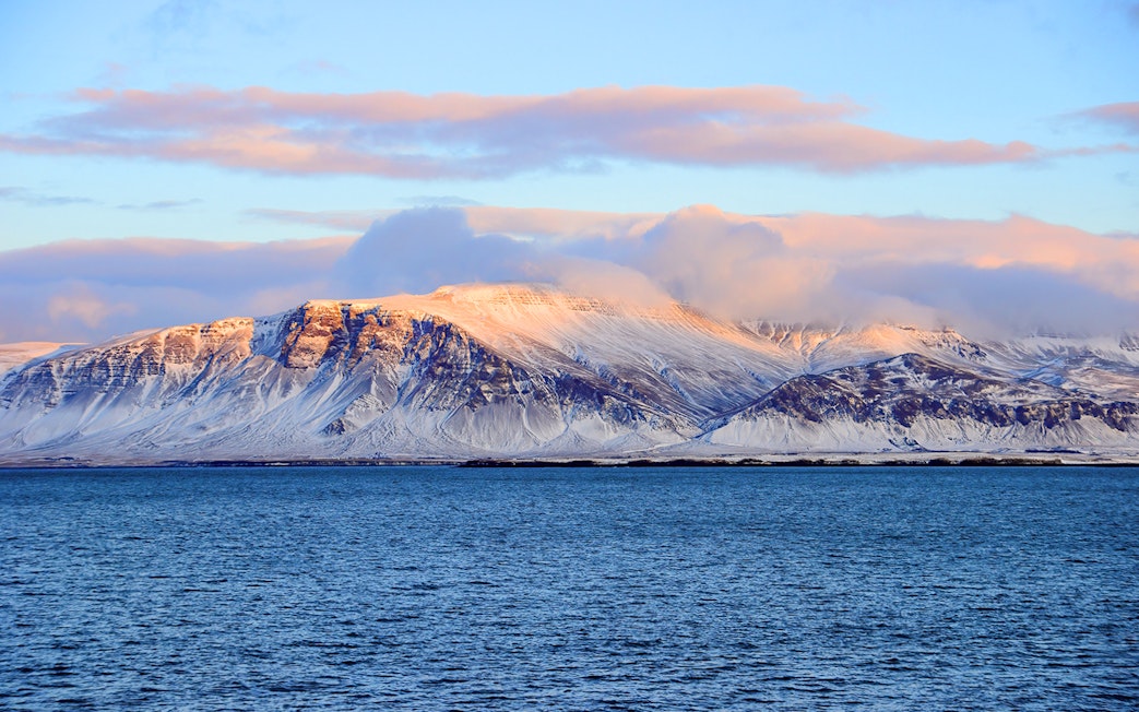 Faxafloi Bay with snowy mountains in Reykjavik, Iceland, popular for whale watching.