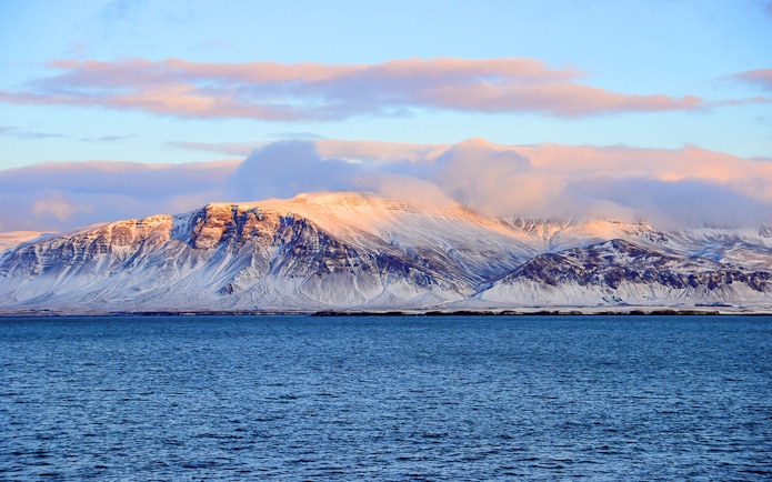 Faxafloi Bay with snowy mountains in Reykjavik, Iceland, popular for whale watching.