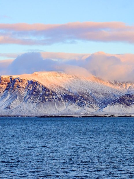 Faxafloi Bay with snowy mountains in Reykjavik, Iceland, popular for whale watching.