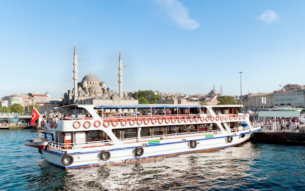 Ferry on the Bosphorus with Istanbul skyline and mosque in the background.