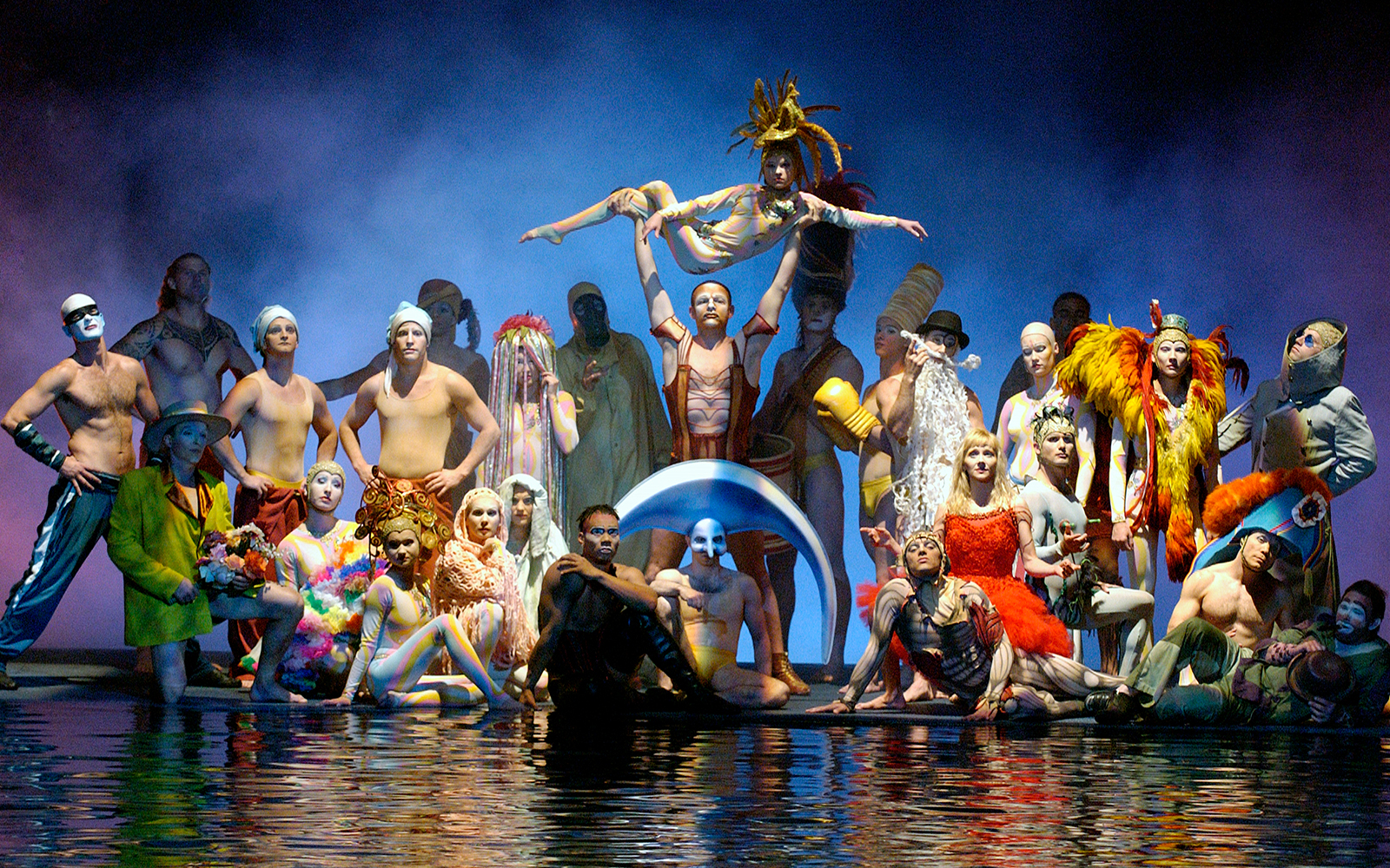 Performers in colorful costumes on stage at Cirque du Soleil's "O" show in Las Vegas.