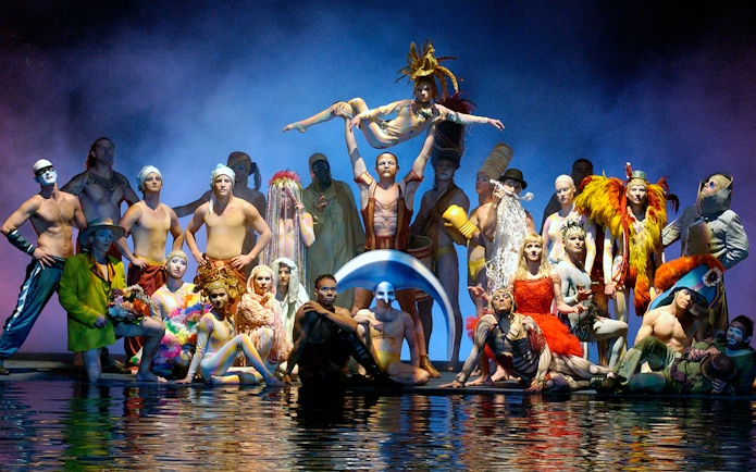 Performers in colorful costumes on stage at Cirque du Soleil's "O" show in Las Vegas.