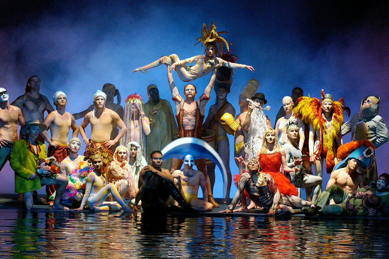 Performers in colorful costumes on stage at Cirque du Soleil's "O" show in Las Vegas.