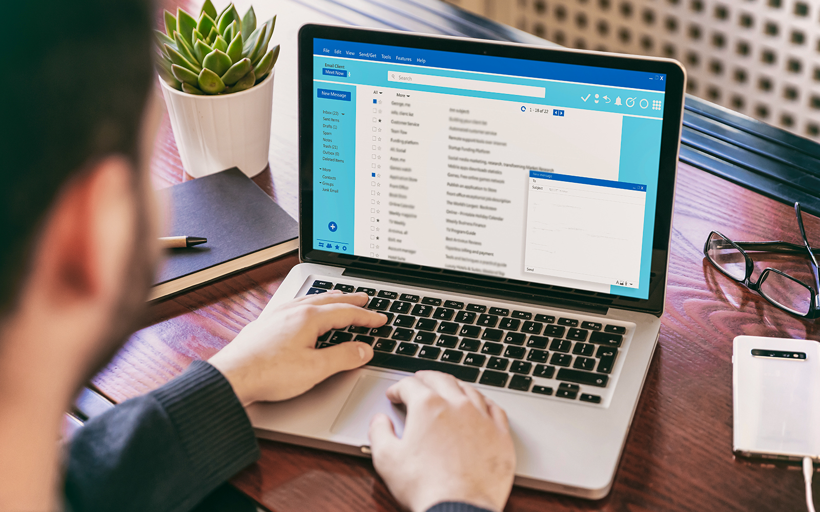 person writing an email to venue