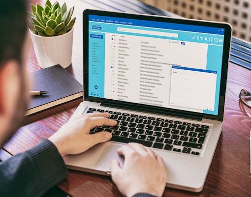 person writing an email to venue