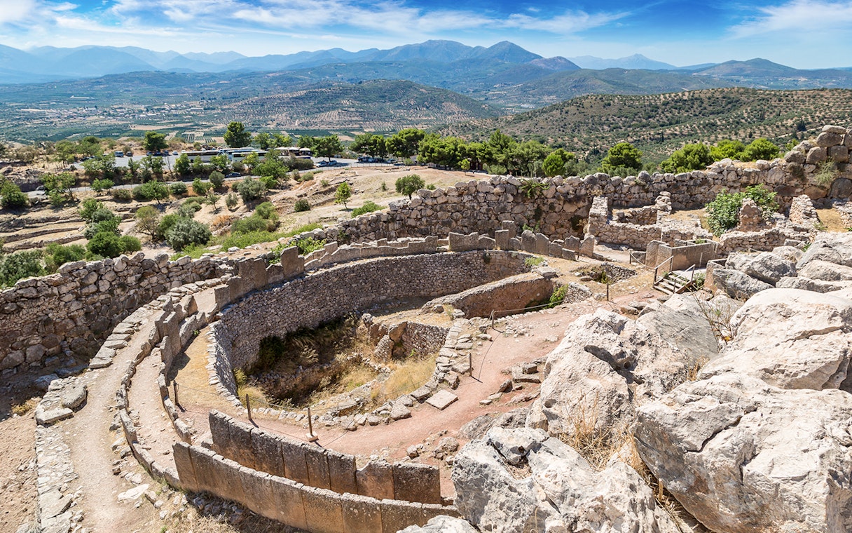 Ancient ruins of Mycenae with mountainous landscape in Greece.