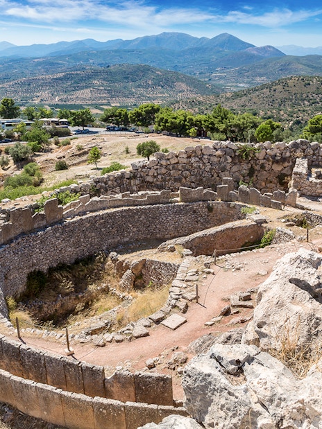 Ancient ruins of Mycenae with mountainous landscape in Greece.