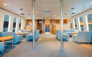 Interior of a luxury yacht lounge with seating and bar on Gold Coast whale watching tour.