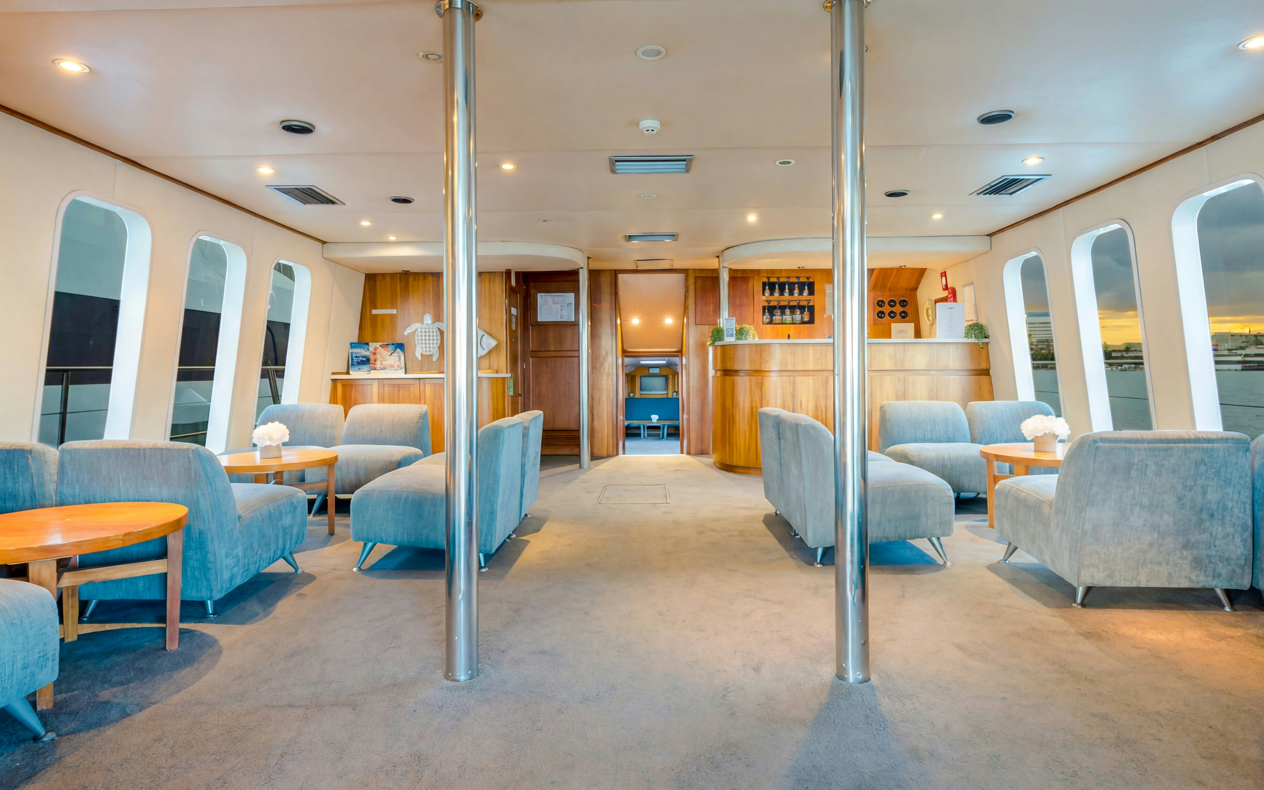 Interior of a luxury yacht lounge with seating and bar on Gold Coast whale watching tour.