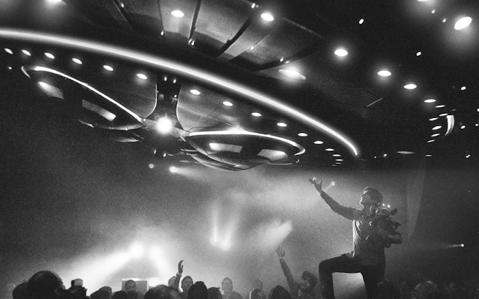 Magician performing under UFO lights at David Copperfield Vegas show.