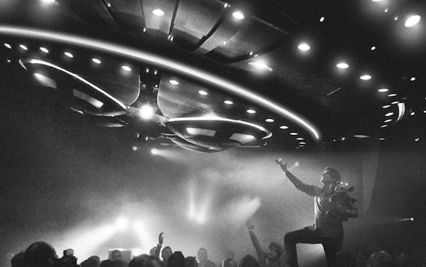 Magician performing under UFO lights at David Copperfield Vegas show.
