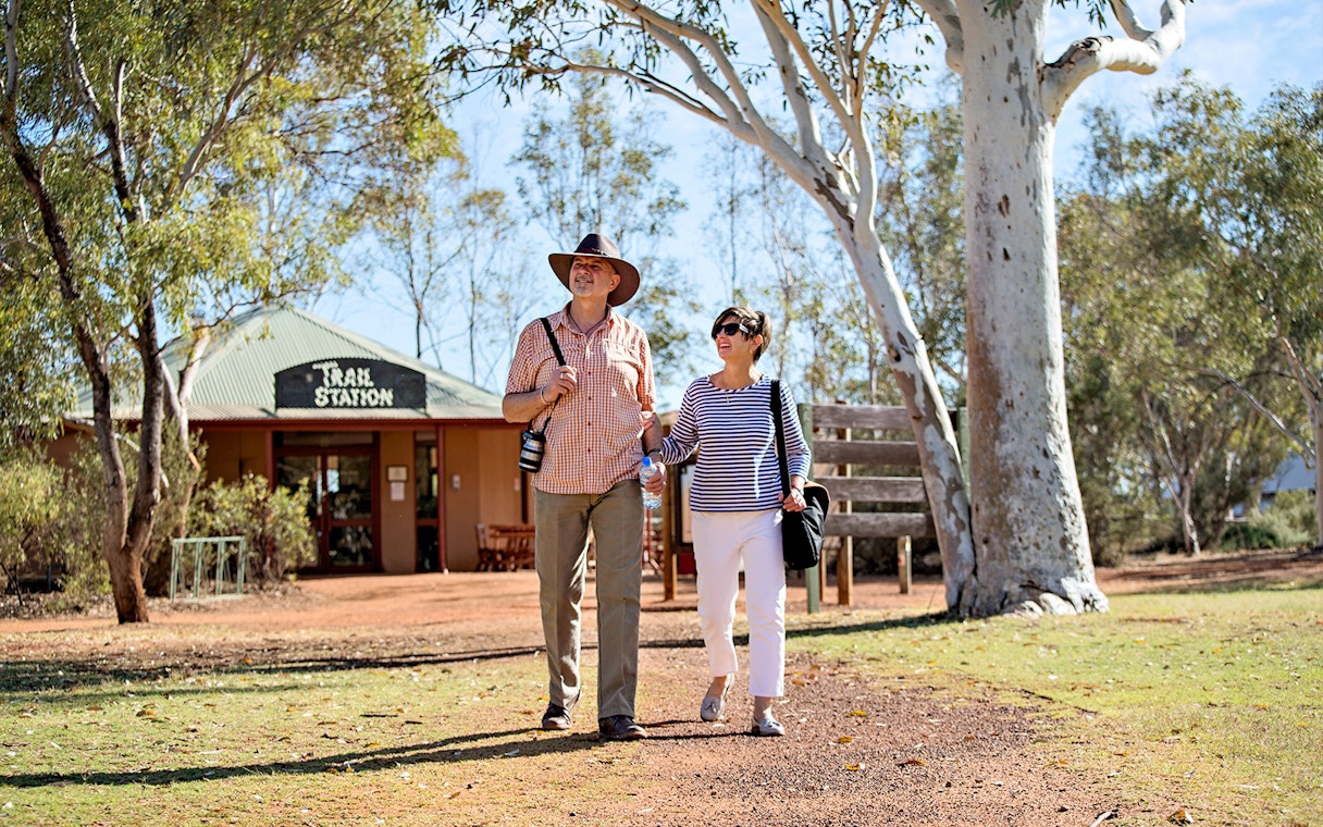 Couple walking near Trail Station in Alice Springs during guided tour.