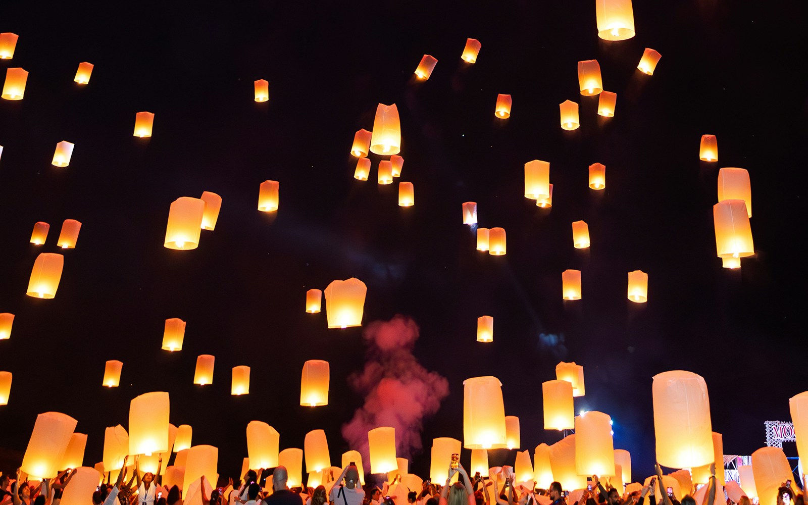 Fireworks and floating lanterns illuminate the night sky at Yi Peng and Loy Krathong Festival 2025, Thailand.