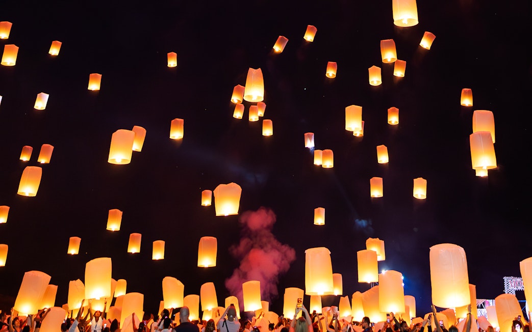 Floating lanterns illuminate the night sky during Yi Peng and Loy Krathong Festival 2025.