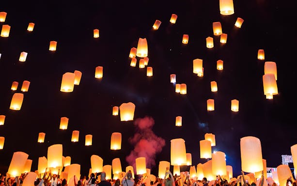 Floating lanterns illuminate the night sky during Yi Peng and Loy Krathong Festival 2025.