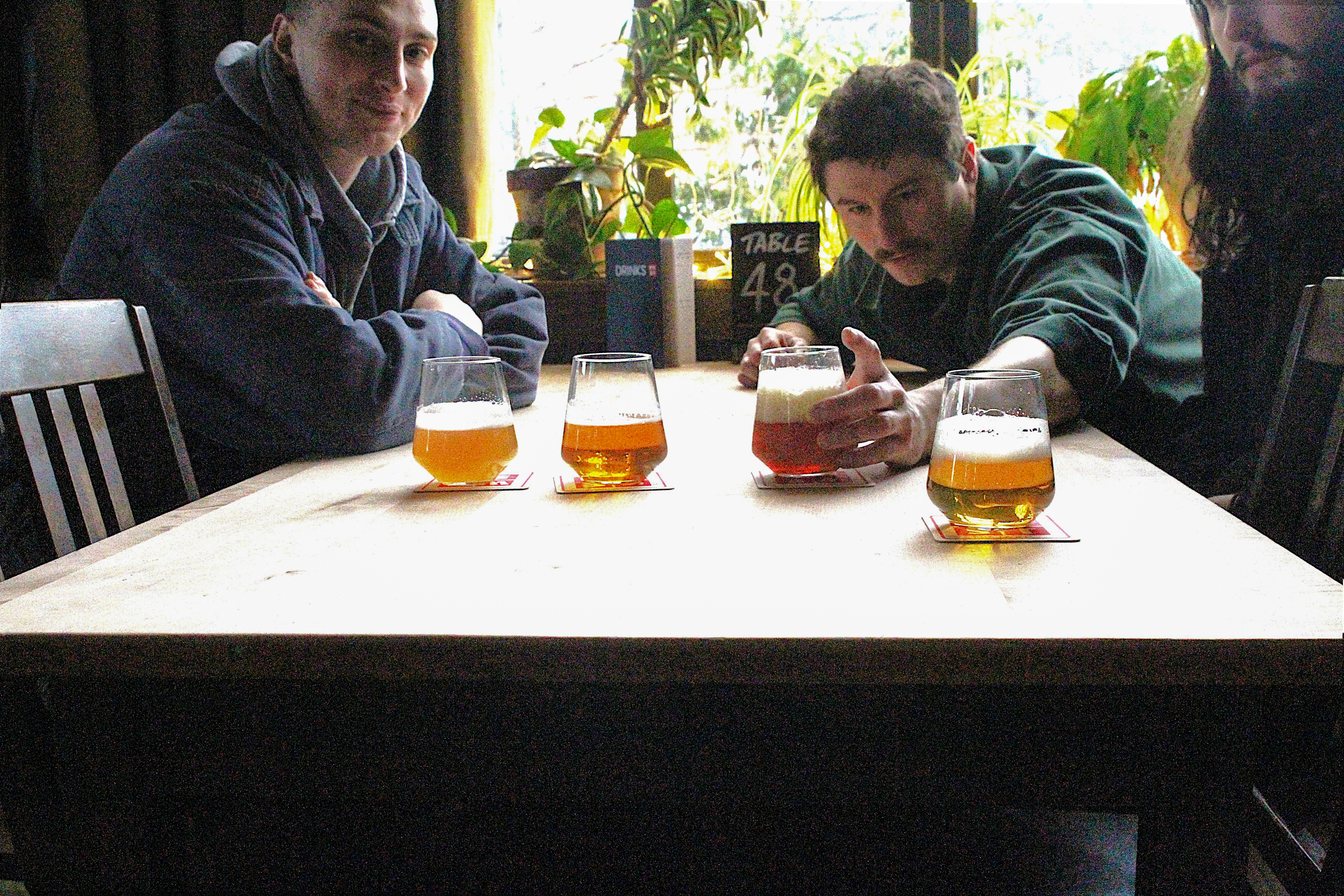 Guests enjoying craft beers at a table during the Glasgow food tour.
