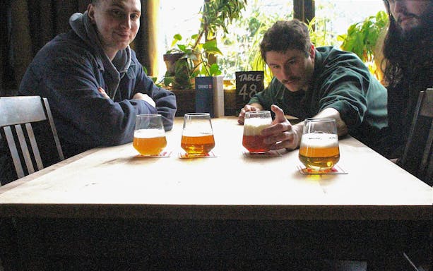 Guests enjoying craft beers at a table during the Glasgow food tour.