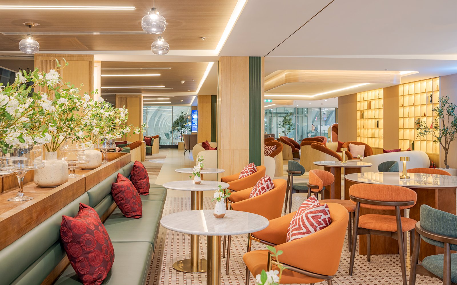 Coral Airport Lounge seating area at Suvarnabhumi Airport with modern decor.